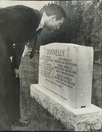 Visitor inspects new Donnelly Gravestone