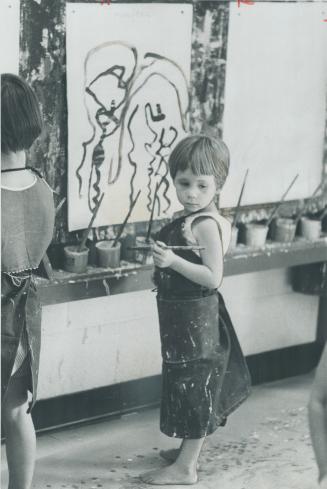 Young artist pauses to work out her ideas for the painting she works on while her parents are out seeing the Expo Sights. Two art classes are held daily at centre