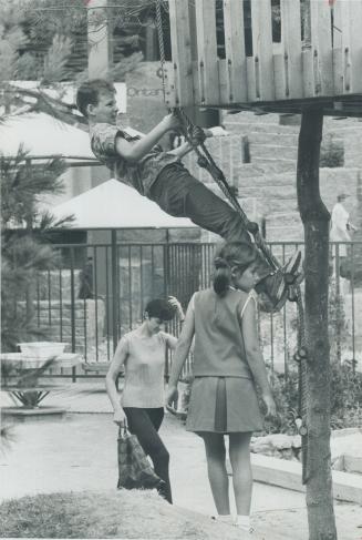 No boy can resist the rope ladder climb to the tree house in the older children's playground at the Canadian Creative Centre at Expo. Playground, whic(...)
