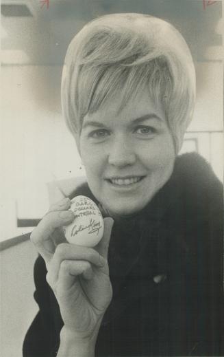Cheque for $15 written on hardboiled egg is held by Barbara Coates