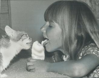 Pair of cool tongues-Amanda Hawthornthwaite, 6, of Bramalea, answers her own and a neighborhood cat's craving-for an ice cream. The cat, Tish, gave bi(...)