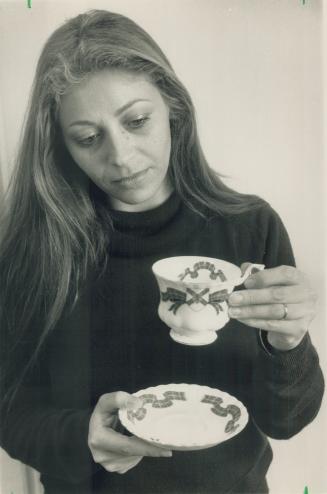 Tea time. Library clerk Rosa Danesh examines a Nova Scotia cup and Saucer, one of the artifacts from the Maritimes on display at Woodside Square libra(...)