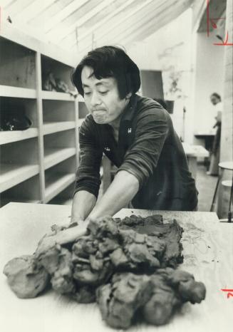 Kimpei Nakamura, a Japanese potter, prepares clay at a YMYWHA workshop in Toronto