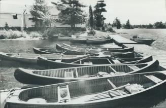 Canoes fill the 'parking lot' of the church which fronts on the main channel of the Trent Waterway