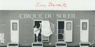 Jinny Jacinto, 15, limbers up in the doorway of the trailer she calls home