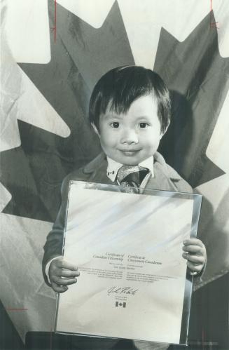 Our newest. Four-year-old Tan Quang Nguyen proudly holds his Canadian citizenship certificate he received last night. He arrived in Canada with his family in 1975 from Viet Nam