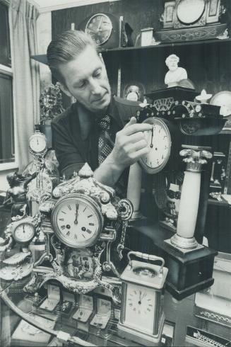 Lloyd Hovey with some of the antique clocks from his collection