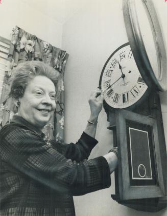 Mrs. Ruth Breithaupt, the RCI's only full-time official, changes the cosmic dial clock