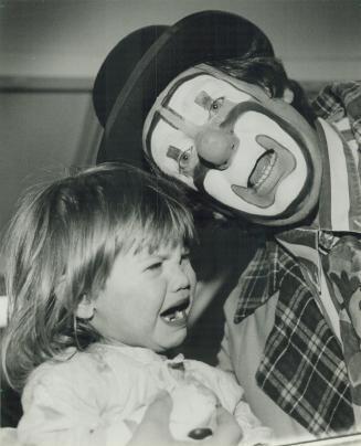 Clowning sorrow. Billy the clown tries his best but just can't pull a smile from little Nikki Bechtel, 2, of Brantford during a visit to the Hospital (...)