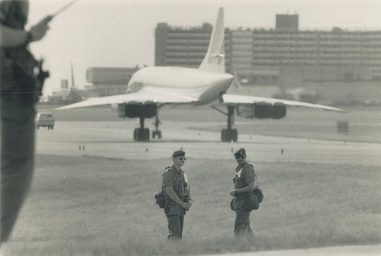 Au Revoir: Soldiers stand guard as a Concorde jet carrying French President Francois Mitterrand roars to takeoff at Pearson International Airport