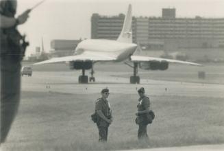 Au Revoir: Soldiers stand guard as a Concorde jet carrying French President Francois Mitterrand roars to takeoff at Pearson International Airport