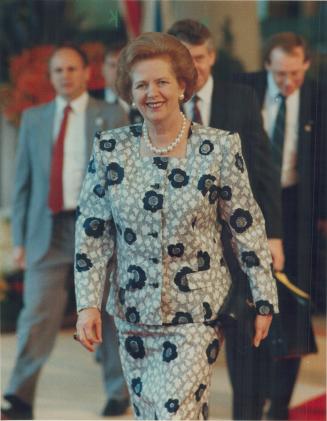 Smiling start: British Prime Minister Margaret Thatcher beams as she passes a crowd of journalists on her way into the meeting