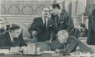 Ontario premier John Robarts (left) confers with Prime Minister Pearson at conference in Ottawa to plan tomorrow's constitution. Behind them are Carl (...)