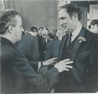 Facing off informally after the opening session of federal-provincial constitutional conference in Ottawa today, Premier Jean-Jacques Bertrad (left) o(...)