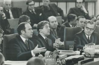 Prime Minister Pierre Trudeau, left, outlines the government's stand on making welfare payments directly to individuals, during the continuing talks o(...)