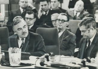 Ontario Premier John Robarts, left, sitting in front of Provincial Treasurer Charles MacNaughton, and beside federal Justice Minister John Turner, rig(...)
