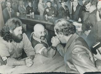 Arm Wrestling at the Habitat Forum bar yesterday, Prime Minister Pierre Trudeau jokes with the bartender, Victree Mallia. Ah, you made that too easy, (...)