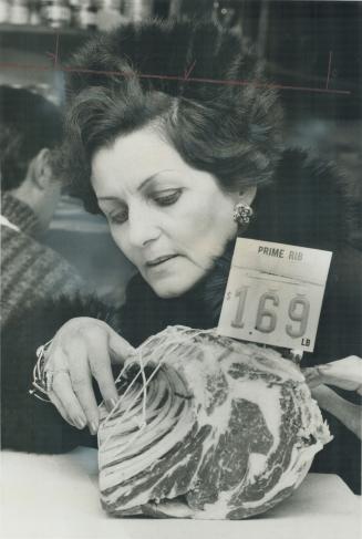 Inflation is frightening says Peggy O'Shea who looks at a piece of meat she used to buy for everyday meals