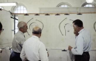 Men studying Viljo Revell drawings for City Hall
