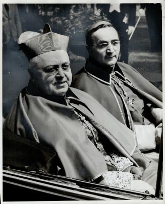Leaving the apostolic delegates' residence for the basilica, where they are attending the Marian Congress, are James Cardinal McGuigan, left, of Toron(...)