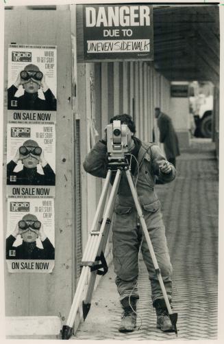 Here's Looking at you. Surveyor Dave Klassen seems to be getting a little help from nearby posters yesterday at the construction site of the World Tra(...)