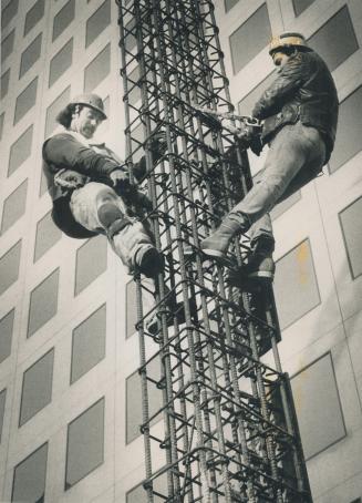 Scaling New Heights. Ironworkers Brian Gary, left, and Graham Halleron are working on the second phase of a 17-storey development at the corner of Bay(...)