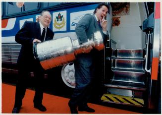 Hey! put that back. Leaf greats Johnny Bower, left, and Darryl Sittler aren't really stealing the Stanley Cup. The Hockey Hall of Fame is hitting the (...)