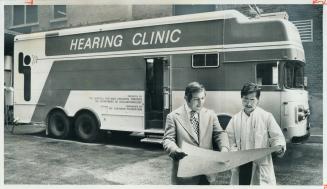 Discussing plans for a mobile hearing clinic's seven-month tour of Northern Ontario are Norman Oppeman (right), a social worker who will co-ordinate t(...)