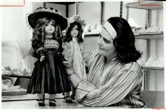 Hello Dolly. Marian Fasan, owner of Marian's Doll House in Richmond Hill, looks over reproductions of antique dolls at her factory. The factory, behin(...)