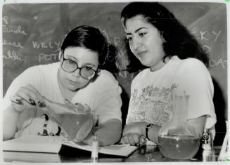 Litmus test: Deborah Baran, left, Fariba Chelehmal work on their chemistry at Britannia Adult Education Centre, a former vocational school now used by adult day students