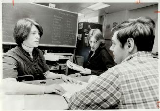Learning to read and write, students Terry Sheckleton (middle) and Doug McDow work with teacher Ethel Anderson