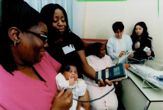 A Day's work: Sandra Smith, left, with daughter Nickesha, checks out 2-day-old Nicole, whose mom, Joan Peck, seated in middle, talks to Anna Lauricella and daughter Frances at York-Finch Hospital