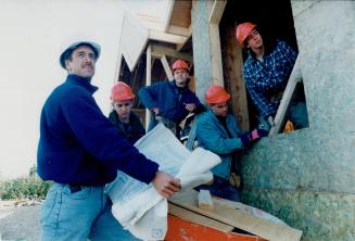 Student Crew: David Holme, a master builder-turned-teacher, studies the house plans with Grade 12 students (from left) Martin Issler, 17, Jason Beever, 18, Kevin Crowley, 17 and Shaun Rounding