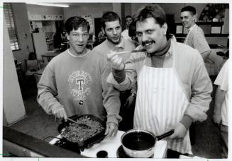 Chili Reception: Sandoz employee Mike Wilmot and student Ron Hilder sample the product of a personal life management class at Henry Street High school, Wilmot's alma mater