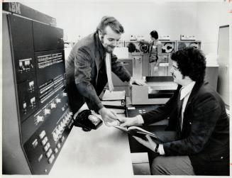 Catalogue orders telephoned into IBM computer are monitored at Simpsons-Sears by John Pritchard (left), project manager, and John Hobbs, operations an(...)