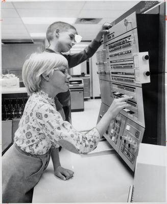 Already learning their way around the new world of the computer are John Armstrong, 6, and his sister Brenda, 8, visitors to the Regional Data Process(...)
