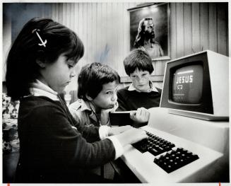 Christianity computes: Jessica and Frank Venezia, and Mike Palmer, right, use a computer terminal at Alderwood United Church in Etobicoke