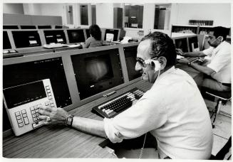 24-hour guard: Jim Karmally, operations supervisor at ADT Security Systems, monitors his firm's computerized alarm system