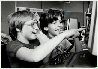 Children like Kim Hampton, 9, (left), and David Demers, 11, are plugging into computer camps with eletronic speed