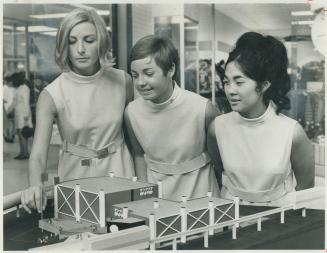 Ricci Richter, Karen Henderson, Kim Morishita with Model of Ontario pavilion