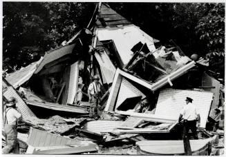Blast levels house, Fire officials inspect a house on David St