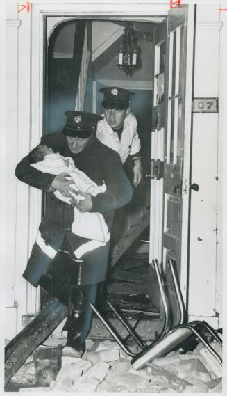 Found buried under a pile of plaster three feet deep, 3-month-old Lorraine Derose is carried unhurt from home by fireman Danny Darnborough after blast