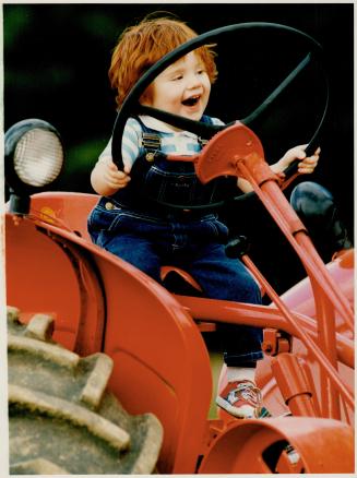 Hey, I got this thing under control, Travis Dunkeld, 2, of Uxbridge, takes command of his granfather's tractor at the recently held Durham Region ploughing match at Byersdale Farm in Blackstock