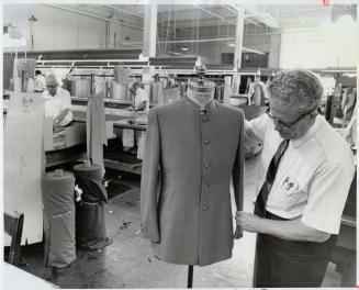 Designer tom Bradford fits a Nehru jacket as the Tip Top Tailors factory prepares to mass-produce the new style