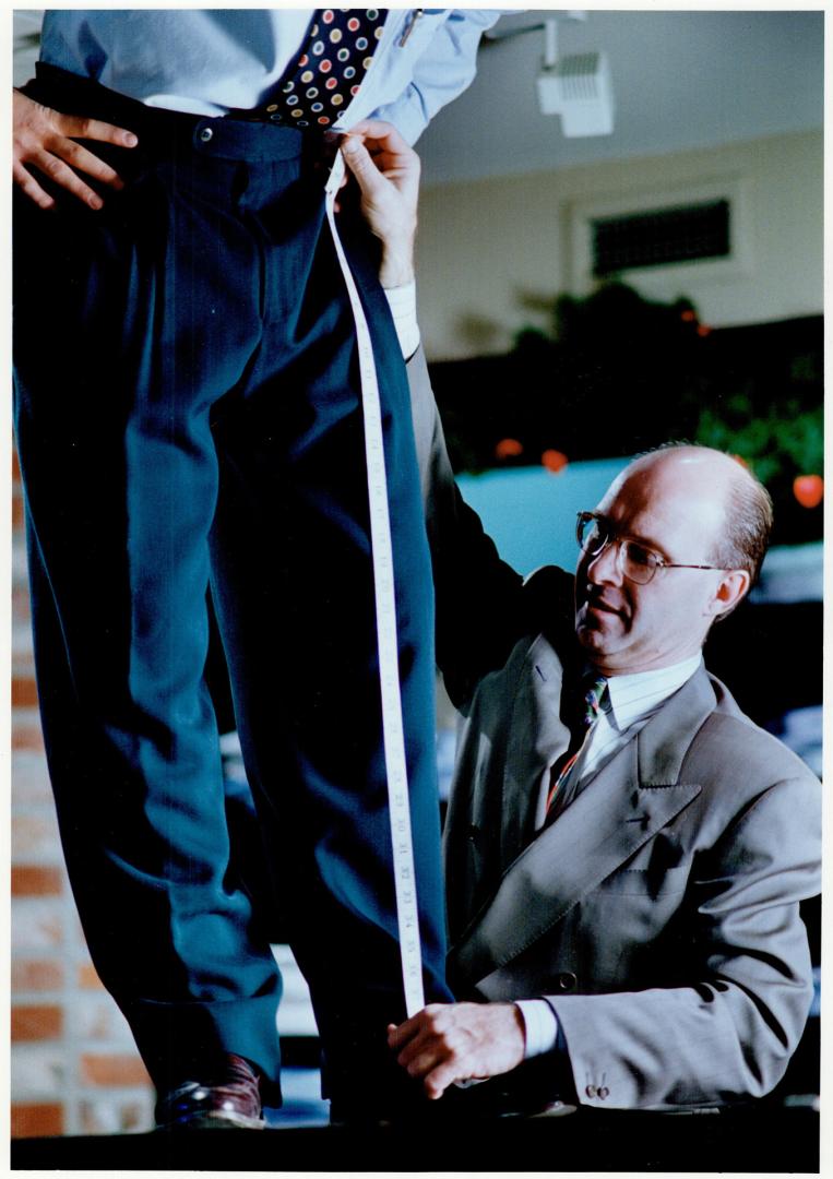 Tailor Ron Burrows measures a man for clothing alterations while, at top, stylist Dolores cuts a client's hair