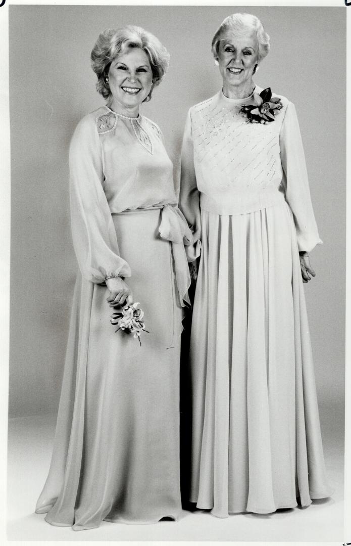 Delicate detail: Above left, the groom's mother wears Nuna Barron's hyacinth blue chiffon dress with net inserts and beading on a matching chiffon overblouse
