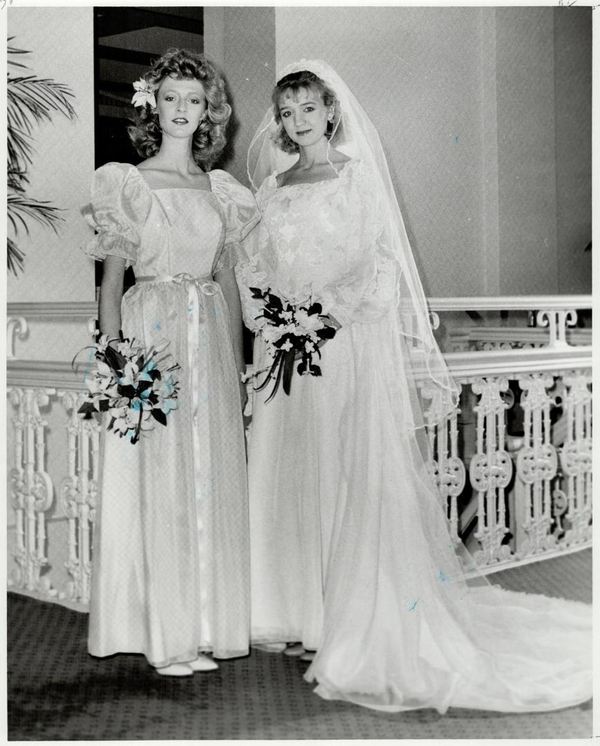 Bride wears ivory heirloom-type organza, attendants wears apricot gown with puffed sleeves
