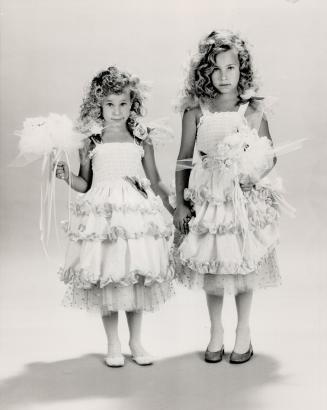 'Boticelli Babes': Jordana, left, and Elyssa Leventhal in white eyelet dresses with satin edging and rosettes, from Peas In A Pod, $140