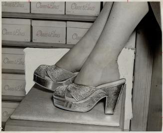 Lovely slippers made of hand-sewn rhinestones on silver kid and priced at $100 the pair, are displayed at a downtown Yonge St. store. They are made in the U.S