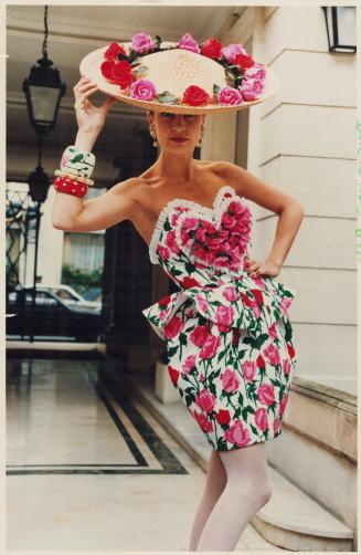 Above right: Christian Lacroix's heart-shaped embroidered strapless bustier and rose printed pique amphora-shaped skirt, straw hat strewn with silk roses, and floral and polka-dot painted bangles